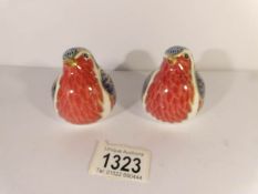 A pair of Crown Derby robin paperweights.