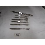 6 decorative silver handled fruit knives and a silver handled table knife.