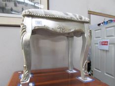 A silver coloured stool.