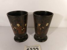 A pair of old Japanese lacquered beakers decorated with figures.