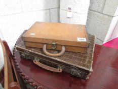 A metal Rowntree tin shaped as and suitcase with contents and one other.
