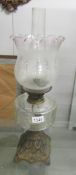 A Victorian oil lamp with original acid etched shade.