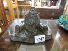 An inkwell in the form of a monk, missing liner.