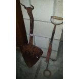 A vintage timber cutter and a stirrup pump