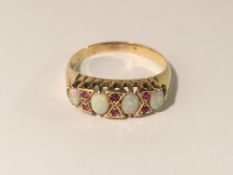 A vintage ruby/opal ring set with 6 rubies and 4 opals in 18ct gold tested.