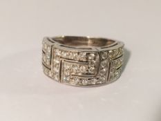 An 18ct white gold diamond set key design ring set with 50 diamonds, size N half.