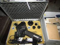 A metal camera case containing a good Minolta camera, lenses, flash etc.