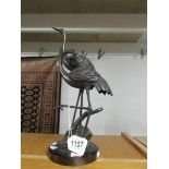 A bronze figure group of 2 cranes.