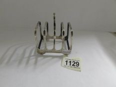 A hall marked silver toast rack.