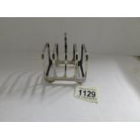 A hall marked silver toast rack.