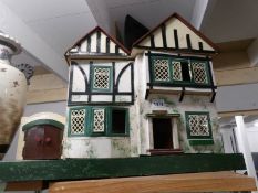 A vintage dolls house and contents.