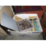 A box of coins, coins folder with coins and coin related books.