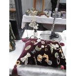 A mixed lot of brooches and 2 necklace stands.