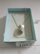 A silver Tiffany 2 heart silver necklace.