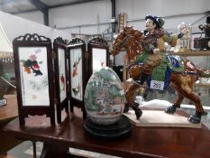 A Tang horse, a painted Chinese egg on stand and a Chinese silk embroidered screen.