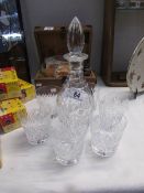 A fine quality crystal decanter and a set of 6 matching glasses.