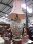 A pottery table lamp with shade.