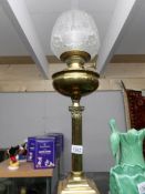 A Victorian brass Corinthian column oil lamp complete with shade and chimney.