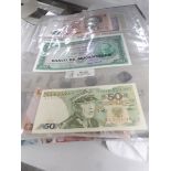 A folder of old bank notes and coins.