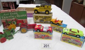 A boxed Cherben's farm tractor with reaper,