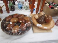 2 bowls of carved wood fruit and eggs.