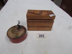 An early 20th century hand wind music box and an inlaid box containing playing cards.