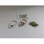 A gold ring with pink stone marked 9ct, a yellow metal ring a/f and a Boy's Brigade badge.