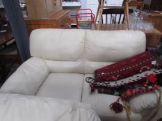 A cream leather 2 seat sofa.