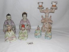 3 pairs of 19th century bisque nodding head figures and a sea saw candle holder.
