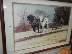 A framed and glazed ploughing print.