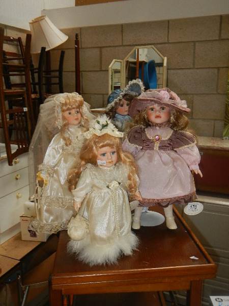 4 porcelain dolls.