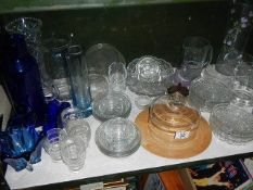 A shelf of assorted glass ware.