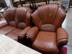 A tan leather 2 seat sofa and chair.