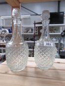 A pair of glass decanters.