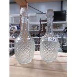 A pair of glass decanters.