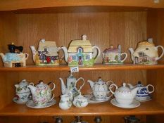 2 shelves of tea ware including teapots.