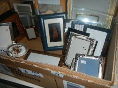 A box of assorted photo frames.