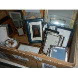 A box of assorted photo frames.