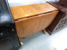 A teak drop leaf table.