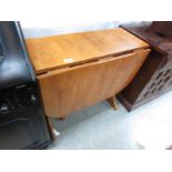 A teak drop leaf table.