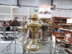 3 brass oil lamp bases and a shade.