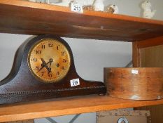 A clock and a circular wooden box.