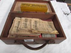 A box of ration books and a tin of Old Holborn dominoes.