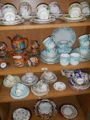 4 shelves of assorted tea ware.