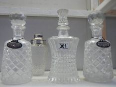 4 glass decanters, 2 with silver labels.