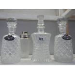 4 glass decanters, 2 with silver labels.