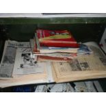 A shelf of old newspapers and magazines.