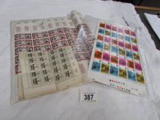 A quantity of sheets of stamps.