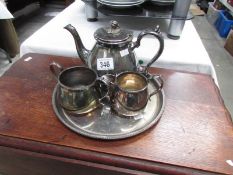 A 3 piece silver plate tea set on tray.