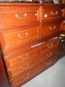 A 2 over 3 chest of drawer and a pair of matching bedside chests,.